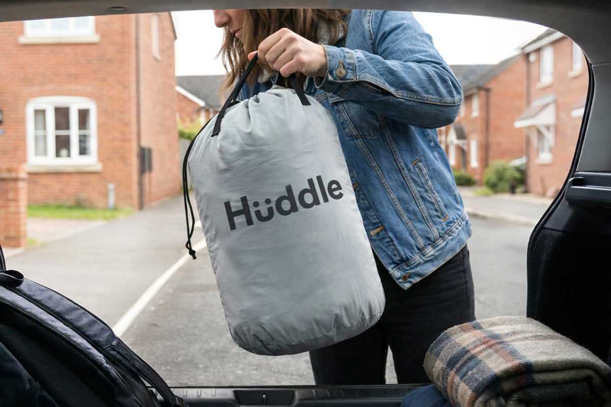 woman putting huddle never deflate™ air bed into the boot of their car